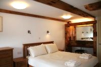 Master bedroom featuring original mill timbers - click to zoom